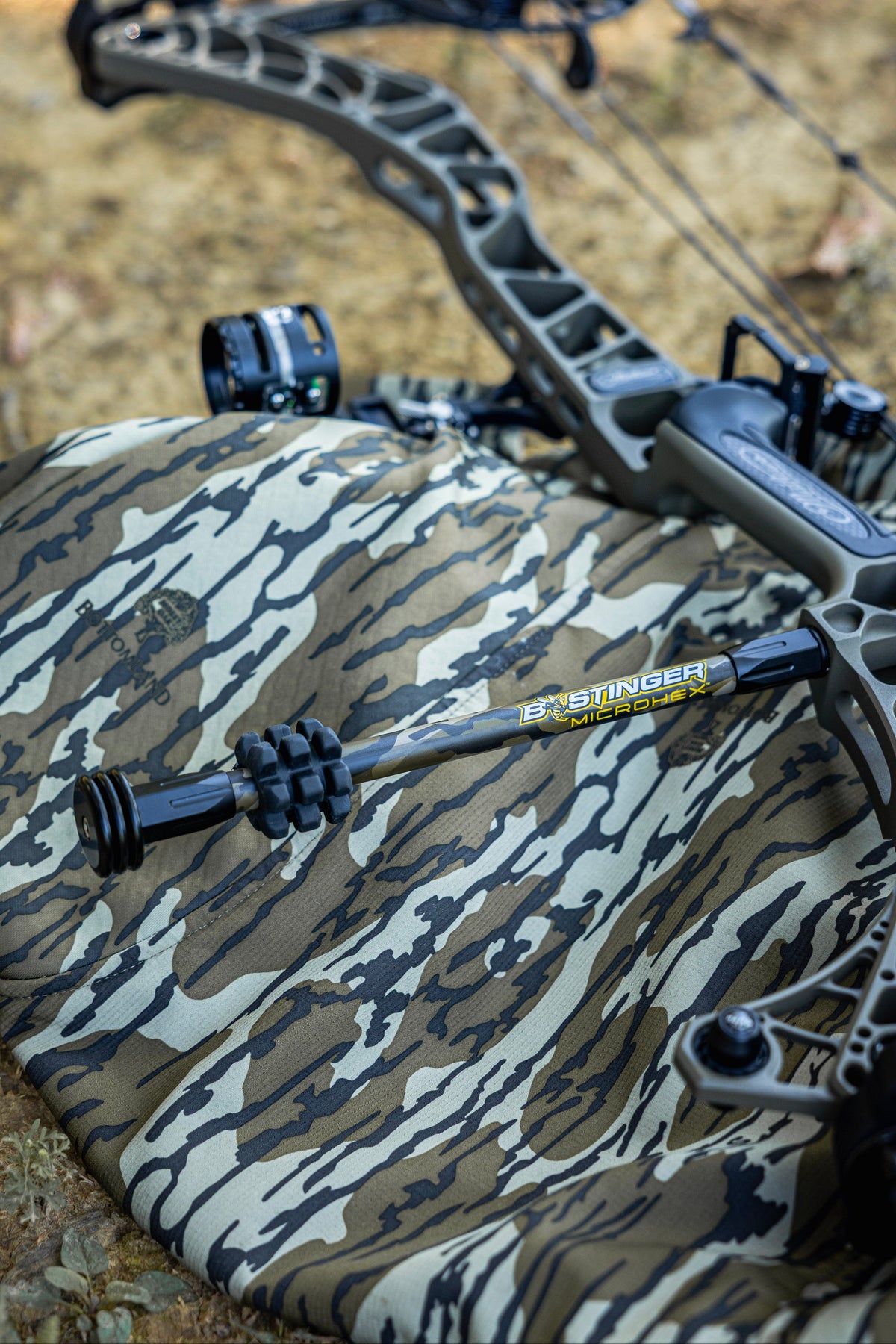 MicroHex Stabilizer in Mossy Oak Bottomland camouflage, a carbon archery stabilizer for hunting bows and compound bow setups, featuring Bee Stinger MicroHex stabilization technology for improved balance and vibration reduction.