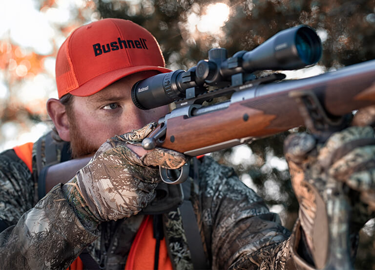 Hunter aiming through Bushnell Riflescope